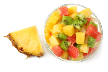 Bowl of healthy citrus fruit salad on light wooden background
