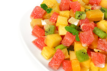 Fototapeta na wymiar Bowl of healthy citrus fruit salad on light wooden background