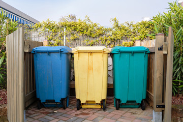 Three types of waste separation tanks on the beach in Italy. Hazardous waste, Dry garbage, wet...