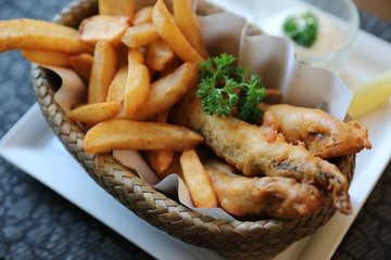 Fish and chips in close up on wood table background