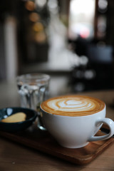 Cappuccino coffee cup on wood background