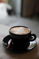 Cappuccino coffee cup on wood background