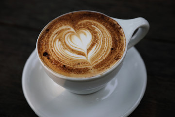 Cappuccino coffee cup on wood background