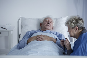 Elderly woman and ill husband