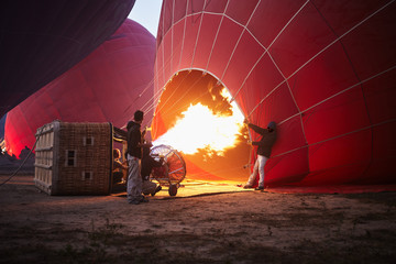 Filling with hot air of red balloons