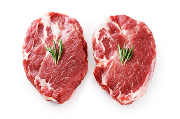 Fresh raw pork steaks and rosemary isolated on white background.