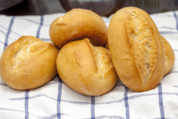 Fresh bread rolls on a towel