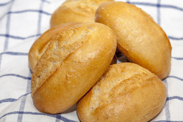 Fresh bread rolls on a towel
