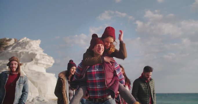 Friends and couples together on an island beach in winter