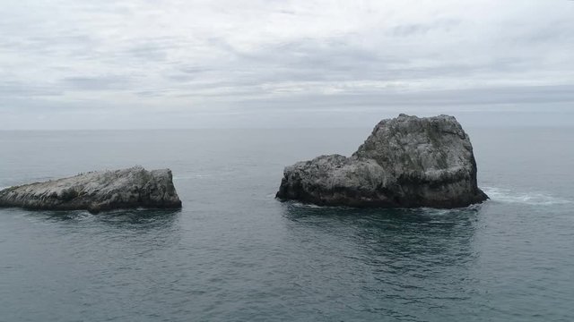 Aerial view of rocks in the ocean water