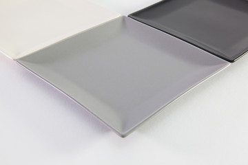 Black, white and gray square plates for sushi