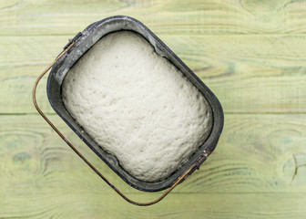 Raw dough for bread in the form of a breadmaker. Preparation of bread in the bakery.