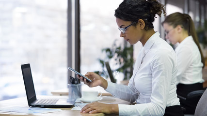 Biracial manager calling client to arrange appointment, business communication