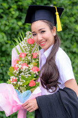 Graduate woman students wearing graduation hat and gown, congratulations for end of study