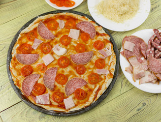 Fresh raw Italian pizza during cooking. Ingredients for pizza.
