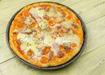 Freshly prepared homemade pizza on a baking dish.