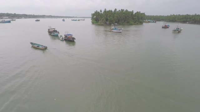 A boat swerving in the middle of the sea near an island.