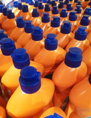 Orange bottles with detergent in the store