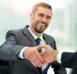 closeup .businessman holds out his hand for a handshake.