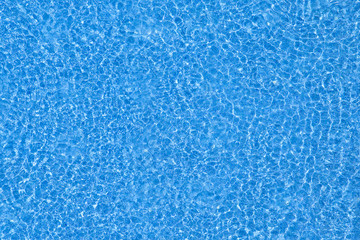 Water ripples texture on blue swimming pool background. Top view