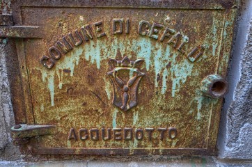 Cefalù, Italy, Sicily August 16 2015. The alleys of cefalù that wind at the foot of the fortress behind the cathedral. Steep stairways, picturesque signs. Narrow streets, flower boxes, laundry threads
