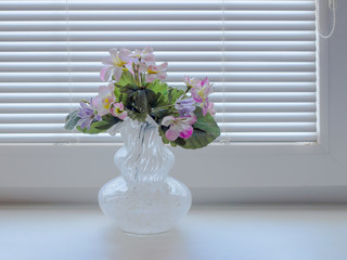 Flowers made of fabric in a glass vase