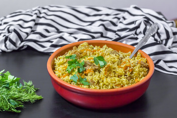 Pilaf with beef, carrots, onions, garlic, pepper and cumin. A traditional dish of Asian cuisine.