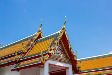 Fototapeta na wymiar art of Buddhism house of worship temple roof in traditional style by red, orange and green color of tile on top roof and Thai architecture