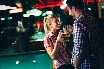 Young attractive couple on date in snooker club