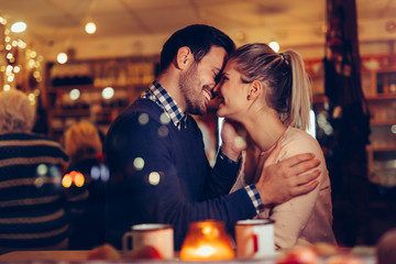 Romantic couple dating in pub at night