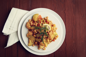 Vegetable stew with chickpeas, cauliflower and cabbages. Organic food. Vegan dish. European cuisine. Vegetarian lunch. Toned photo. Close up. Top view.