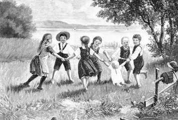 Kinder beim Spiel auf der Wiese im Frühling; Ringelreihen