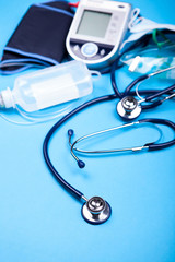 Medicinal equipment with a stethoscope in front on blue background