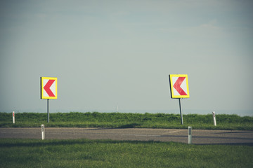 Turn left sign on a country road