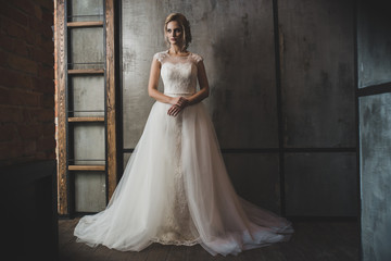 woman in wedding dress posing in luxury interior