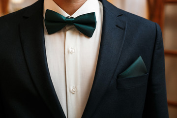 Groom black suit with a bow tie