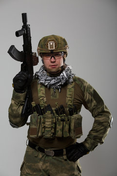 Picture soldier in goggles with gun in his hand