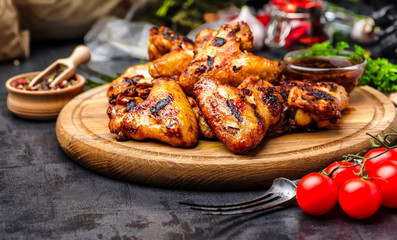 Grilled or oven roasted chicken wings glazed with barbecue sauce