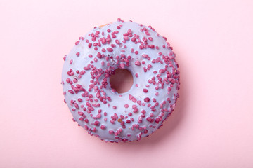 Sweet glazed raspbrery donut on pink background
