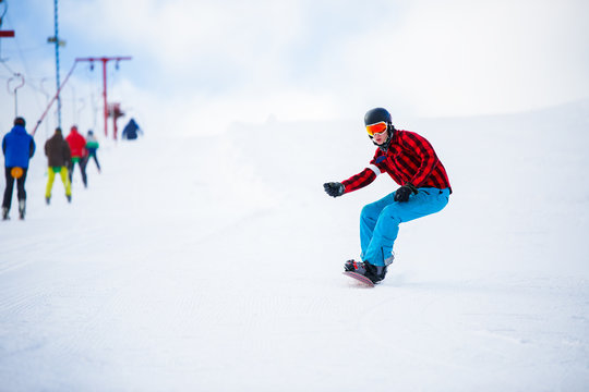 Photo of athlete with snowboard jumping on snowy hill