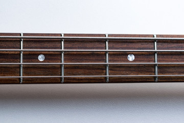 Frets on bass guitar. Close up. Vintage old retro bass in studio