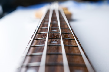 Frets on bass guitar. Close up. Vintage old retro bass in studio