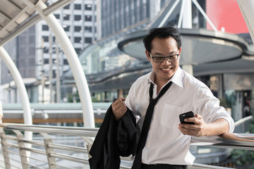 Happy and glad businessman holding phone .