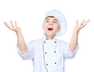 Cheerful handsome teen boy wearing chef uniform. Portrait of a happy cute male child cook with raising hands, isolated on white background. Food and cooking concept.