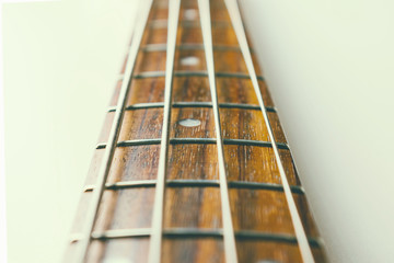 Frets on bass guitar. Close up. Vintage old retro bass in studio. Warm soft style