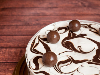 Delicious light ice cream cake with chocolate on dark background