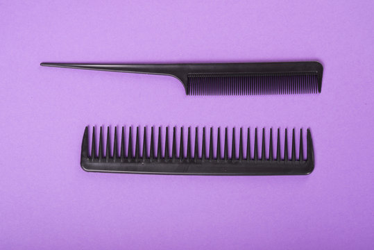 Two combs on purple background.