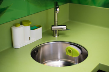 Wash dishes beautifully sponge green in the kitchen cleanliness