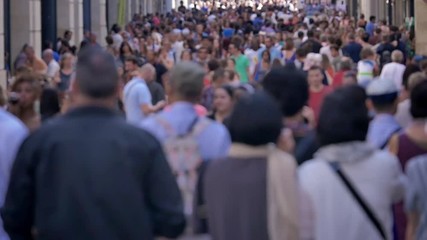 Crowd walking in a large street. Slow motion footage of anonymous people walking