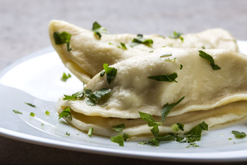 Pierogi, pyrohy or dumplings, filled with meat covered with herbs